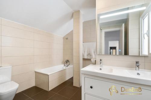 a bathroom with a sink and a toilet and a mirror at Exclusive Málaga Soho Apartment in Málaga