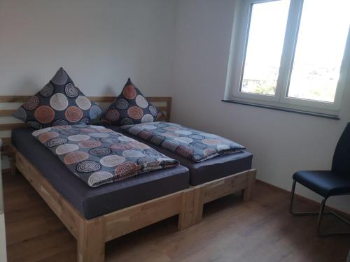a bed with two pillows on it in a room at Franzl Hof Zorell in Ravensburg