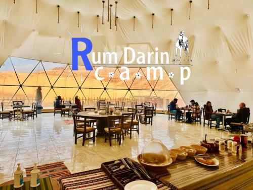 a restaurant with tables and chairs in a building at Rum titanic camp in Wadi Rum
