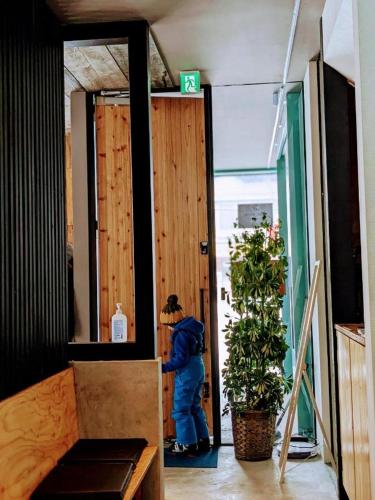 a person standing in a door in a room at Tbox in Kutchan