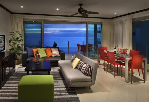 a living room with a couch and a table at Best in Jaco Condos at Diamante del Sol in Jacó