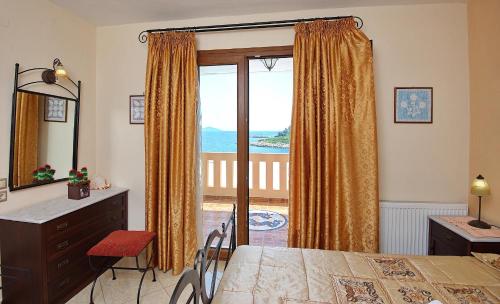 a bedroom with a bed and a window with a view at Sossinola in Steni Vala Alonissos
