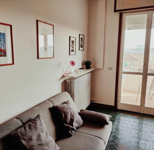 a living room with a couch and a window at La terrazza sul mare in Cesenatico