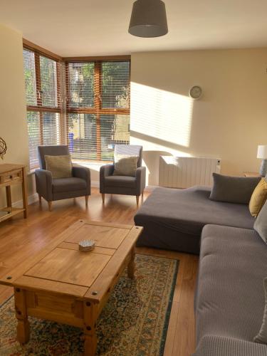 a living room with a couch and a coffee table at Glengesh Court. Ardara town centre. in Ardara