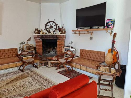 a living room with a couch and a fireplace at Dar Monia Aïn-Draham in Jendouba