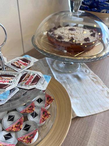 a chocolate cake on a glass plate on a table at ARTEMIDE "Fiore Club" B&B SUITE SPA in Giffoni Valle Piana