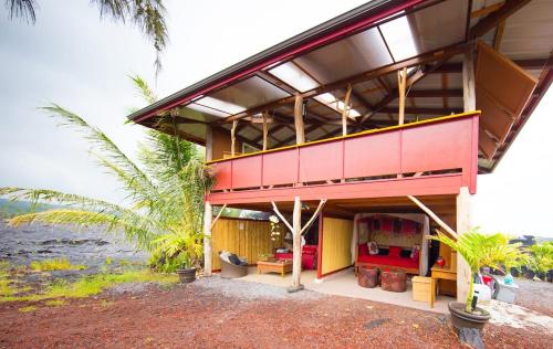 a house on the beach with a view of the ocean at THE MAGICAL LAVA TEMPLE with EPIC Volcano Views! in Kehena