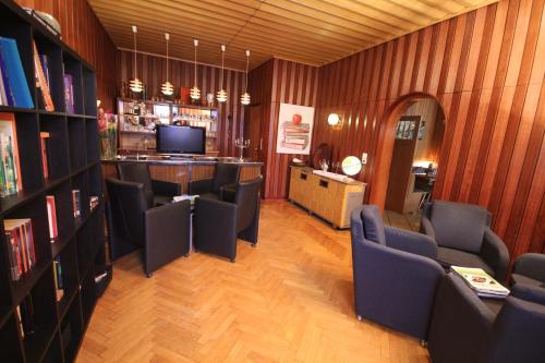 a living room with chairs and a bar in a room at Hotel & Restaurant Druidenstein in Trautenstein
