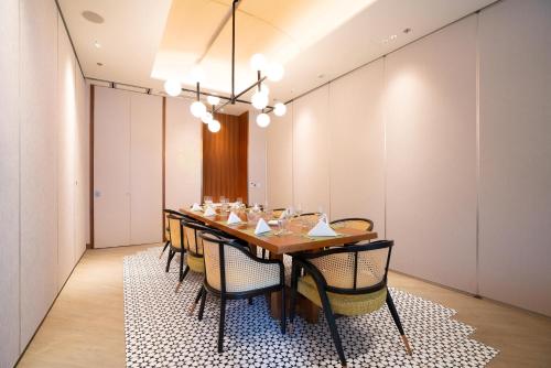 a dining room with a table and chairs at Lotte Hotel Saigon in Ho Chi Minh City