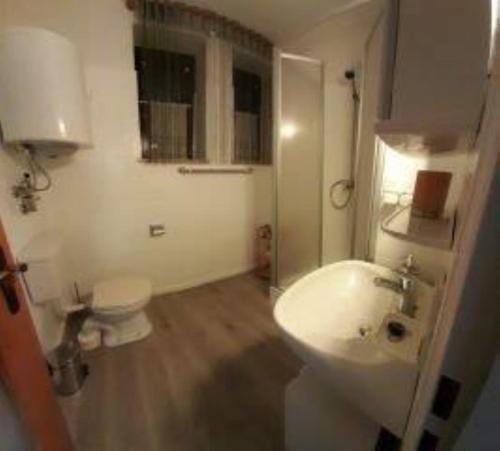 a bathroom with a white sink and a toilet at Ferienwohnung Meister in Bad Reichenhall