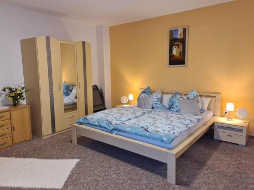 a bedroom with a bed with blue sheets and pillows at Ferienwohnung Meister in Bad Reichenhall