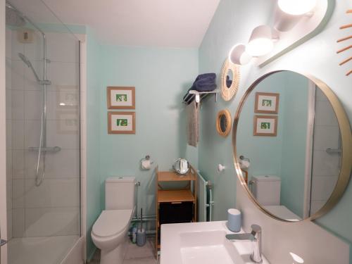 a bathroom with a toilet and a sink and a mirror at Apt 2/4 pers. Arcachon + Parking / Le Perchoir in Arcachon
