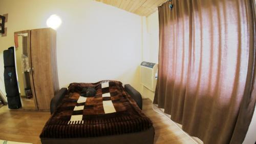 a living room with a couch in front of a curtain at Mary Apartment Gudauri Residence in Gudauri