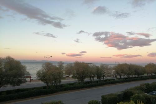 a view of the ocean at sunset from a balcony at Galini Palace in Athens