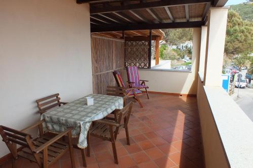 a patio with a table and chairs on a balcony at Le Soleil in Campo nell'Elba