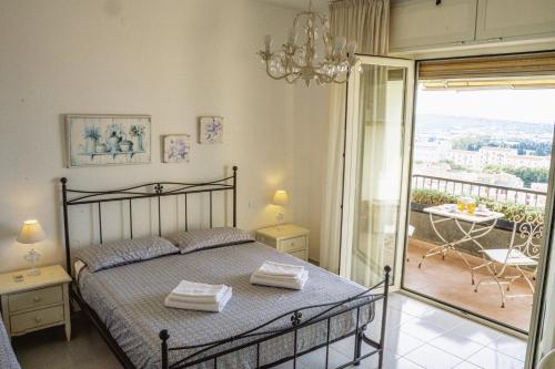 a bedroom with a bed and a balcony at S'ARD Guest House Sassari in Sassari