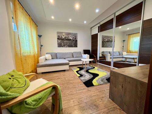 a living room with a couch and a table at Rabbit apartman in Mosonmagyaróvár