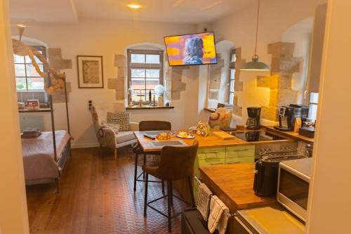 a kitchen with a table and a dining room at Holzwerk Oybin in Kurort Oybin