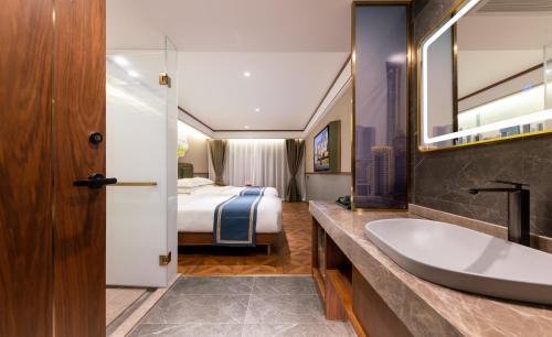 a bathroom with a sink and a bed at Nostalgia S Hotel Beijing CCTV in Beijing