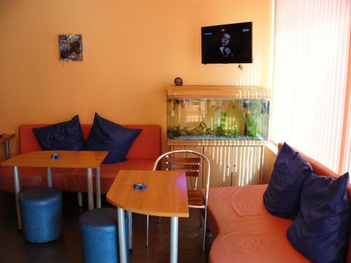a living room with a couch and a fish tank at Family Hotel Jemelly in Obzor
