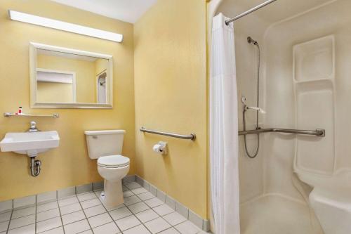 a bathroom with a toilet and a sink and a shower at Super 8 by Wyndham Findlay in Findlay