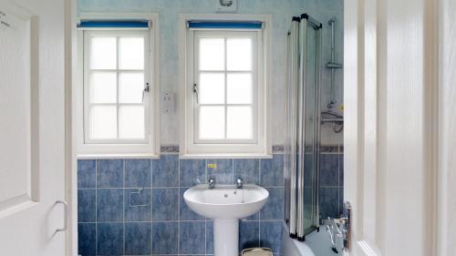 a bathroom with a sink and a shower at 28 Tudor Court, Tolroy Manor in Hayle