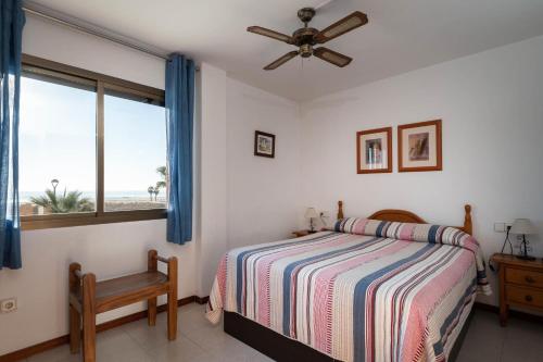 Schlafzimmer mit einem Bett und einem Fenster in der Unterkunft AT118 Solarium Mar in Torredembarra