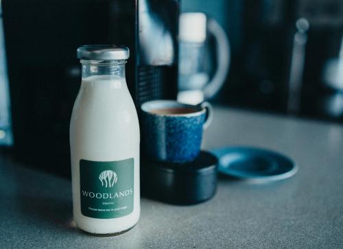 a bottle of milk is sitting on a counter at SeaBeds - Luxury Lookouts with Hot Tubs in Glencoe