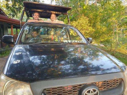 two people sitting in the back of a car at Ceylon Resort Wilpattu in Wilpattu