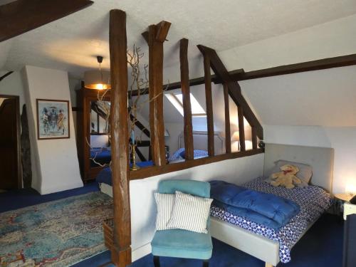 a bedroom with a bunk bed with a teddy bear on it at La Ferme Familiale in Faverolles