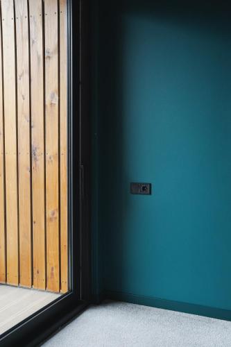 a room with a blue wall and a sliding door at About Sololaki in Tbilisi City