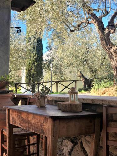 a wooden table in front of a tree at Casale l'Antica Mola in Castel Madama