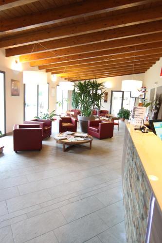 a lobby with couches and tables in a building at Hotel Del Parco in Vigevano