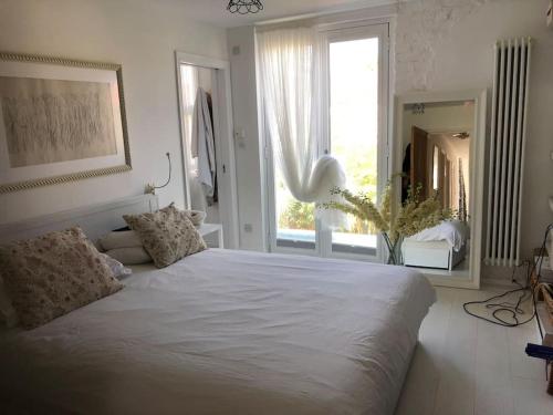 - une chambre avec un grand lit blanc et une fenêtre dans l'établissement Stunning Richmond Maisionette with rooftop patio, à Richmond