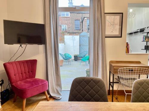 a living room with a table and chairs and a window at Harley's House in York