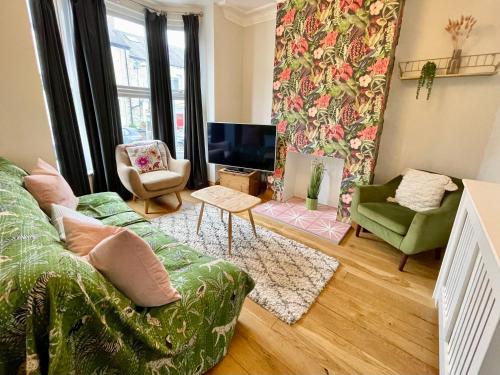 a living room with a couch and a tv at Harley's House in York