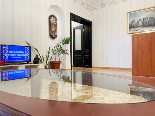 a lobby with a glass table and a black door at DAY & NIGHT in Odesa