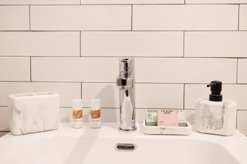 a bathroom sink with soap and cosmetics on it at The Bellini House by House In Naples in Naples