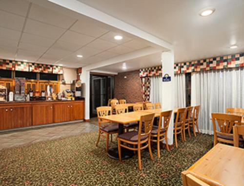 a dining room with wooden tables and chairs at Days Inn by Wyndham Rutland/Killington Area in Rutland