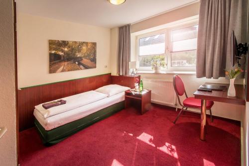 a hotel room with a bed and a desk and a chair at Alte Bäckerei in Parchim