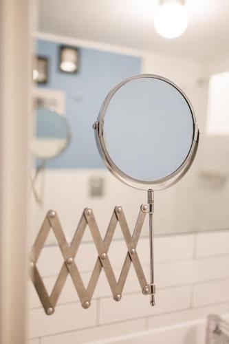 a mirror hanging on the wall in a bathroom at The Bellini House by House In Naples in Naples