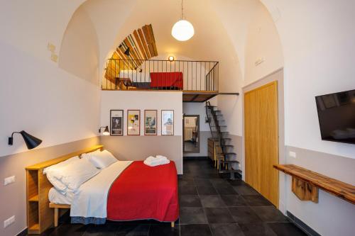 a bedroom with a bed with a red blanket at The Bellini House by House In Naples in Naples