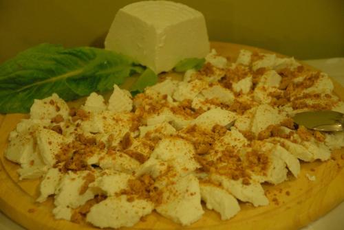 a plate of food with a block of cheese and lettuce at Hotel Iacone in Chieti