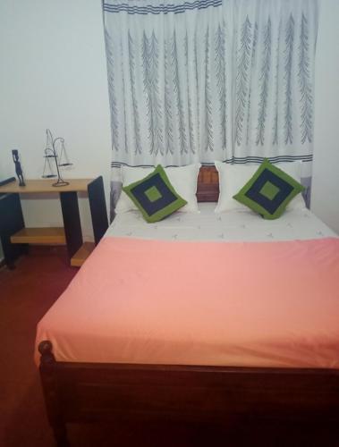 Un pat sau paturi într-o cameră la Cinnamon Villa Boossa