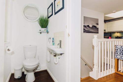 a bathroom with a toilet and a sink at Mews House in Brighton & Hove