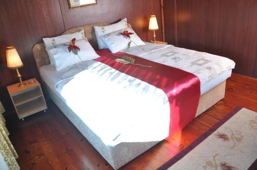 a bedroom with two beds with red bows on them at Hotel Brod Panini Veles in Veles