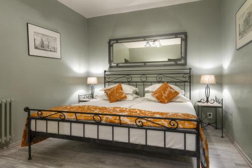a bedroom with a bed with a large mirror on the wall at Black Star Suites in Prague