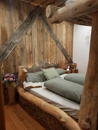 a bedroom with two beds with wooden walls at La Bottega del Drago in Santa Brigida