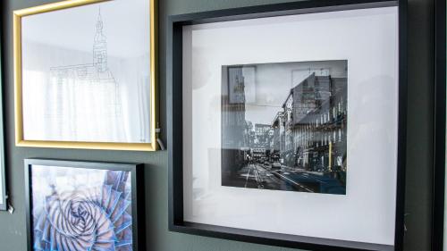 two framed pictures of a city on a wall at Apartment Gallery Zagreb in Zagreb