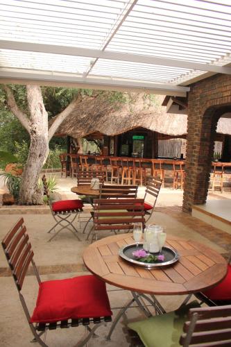 a patio with a table and chairs and a building at Idube Game Reserve in Sabi Sand Game Reserve